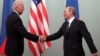 RUSSIA -- Then U.S. Vice President Joe Biden (L) shakes hands with then Russian Prime Minister Vladimir Putin during their meeting in Moscow, March 10, 2011