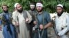 Afghanistan -- Taliban militants stand with residents as they took to the street to celebrate cease-fire on the second day of Eid in the outskirts of Jalalabad, 16June2018
