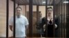 BELARUS -- Belarusian opposition figures Maryya Kalesnikava and Maksim Znak, charged with extremism and trying to seize power illegally, stand inside a defendants' cage as they attend a court hearing in Minsk, September 6, 2021